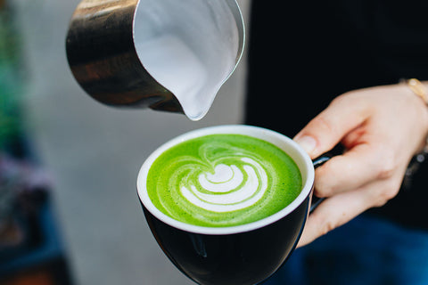 A delicious, vivid green matcha latte being served